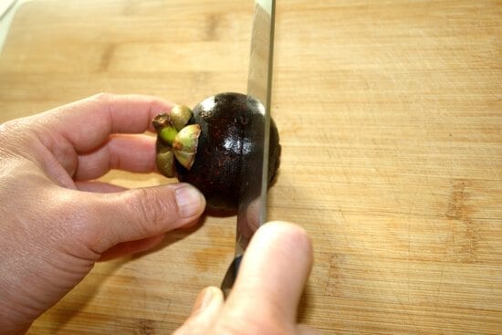 cutting open a mangosteen