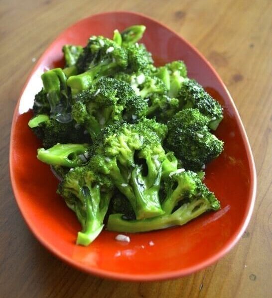 Stir-fried broccoli with garlic in red bowl