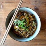 Mushroom noodles in bowl with chopsticks