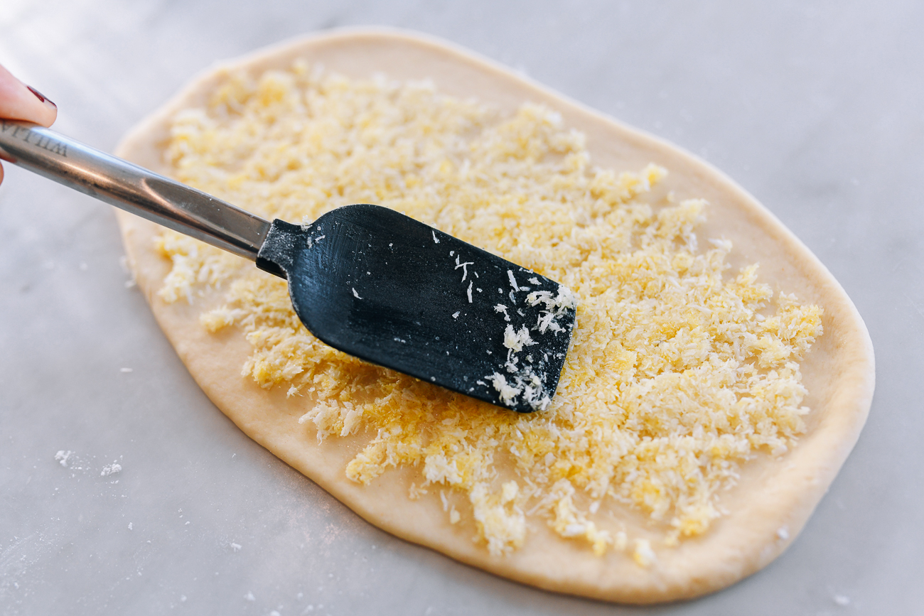 Spreading filling onto flat piece of dough