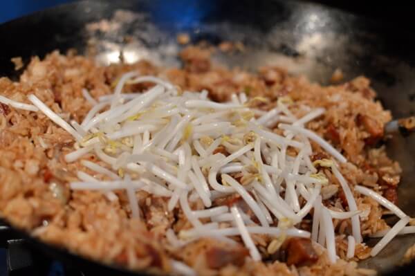 Adding mung bean sprouts to fried rice, by thewoksoflife.com