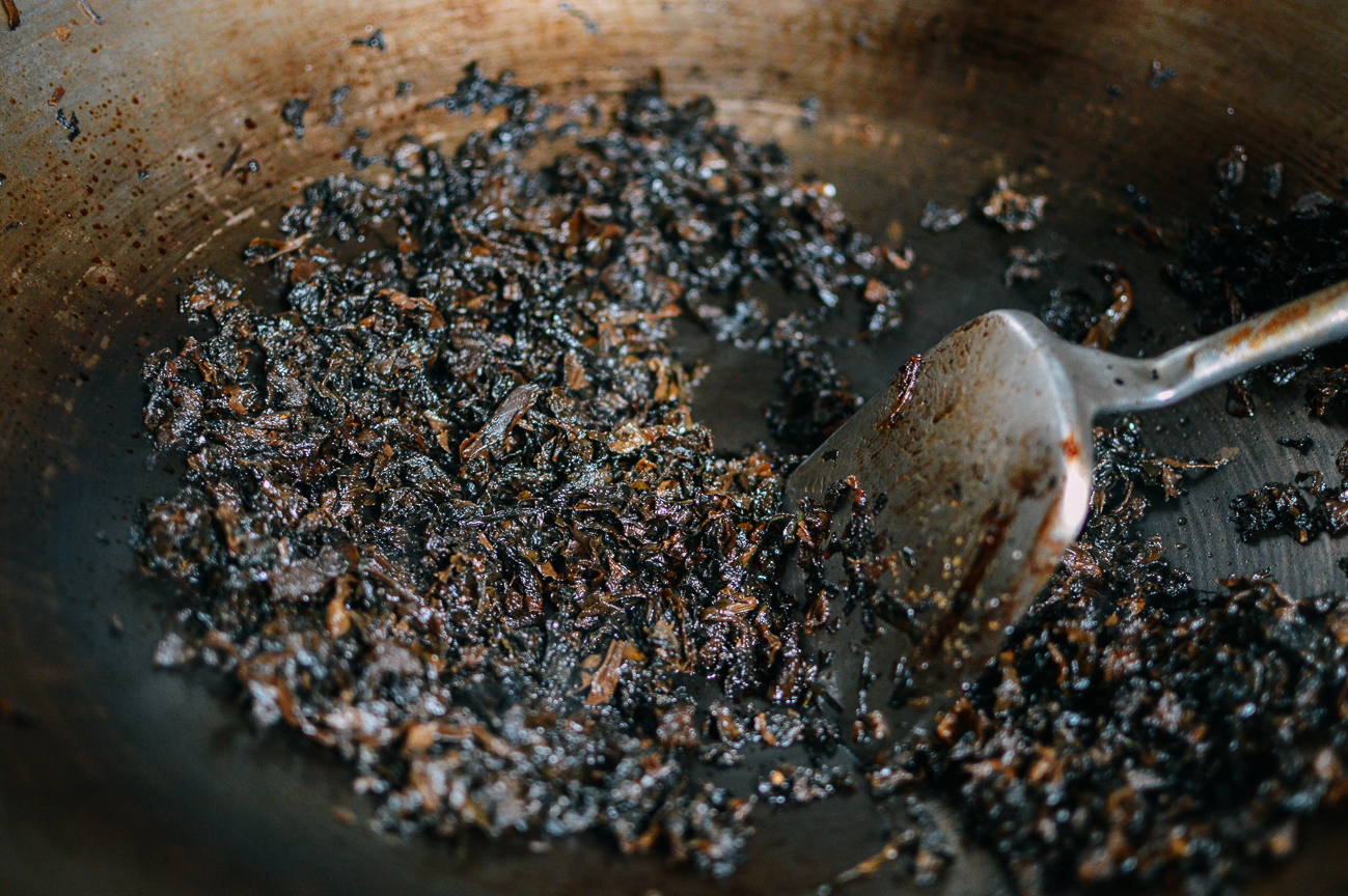 stir-frying soaked moy choy in wok