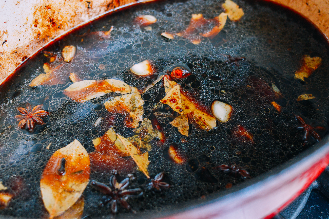 soy sauce, water, and aromatics in dutch oven pot