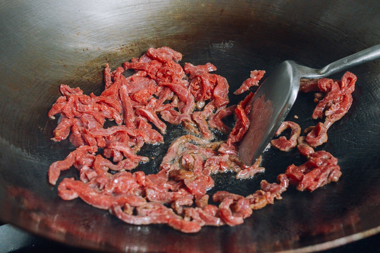 thin strips of beef in wok