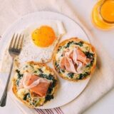 Kale prosciutto english muffin melts with fried egg and orange juice