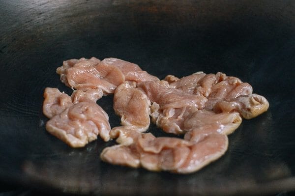 Searing Sliced Chicken in Wok, thewoksoflife.com