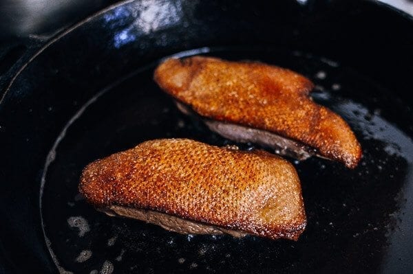 Searing duck breast in cast iron pan, by thewoksoflife.com