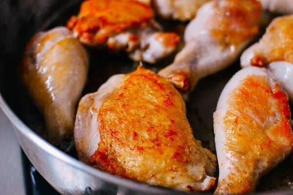 Searing Chicken legs and thighs, by thewoksoflife.com