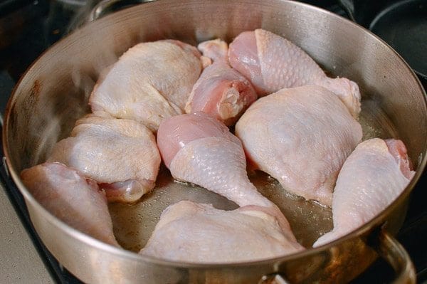 Chicken legs and thighs in pan, by thewoksoflife.com