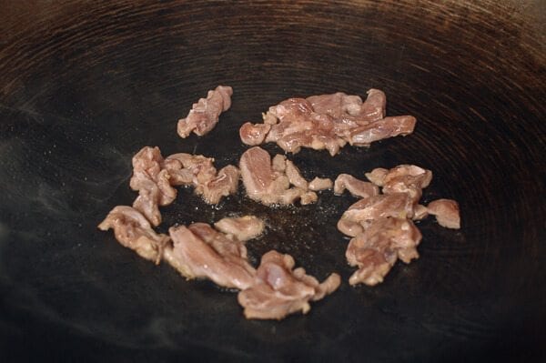 Searing chicken in wok, by thewoksoflife.com