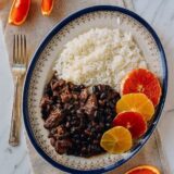 Feijoada with rice and sliced oranges