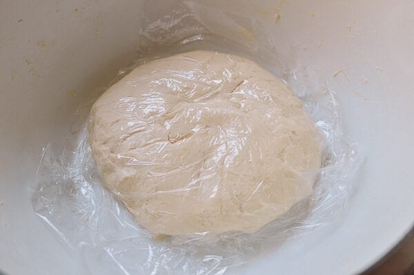 resting dough under plastic for Shanghai Scallion Pancakes, by thewoksoflife.com