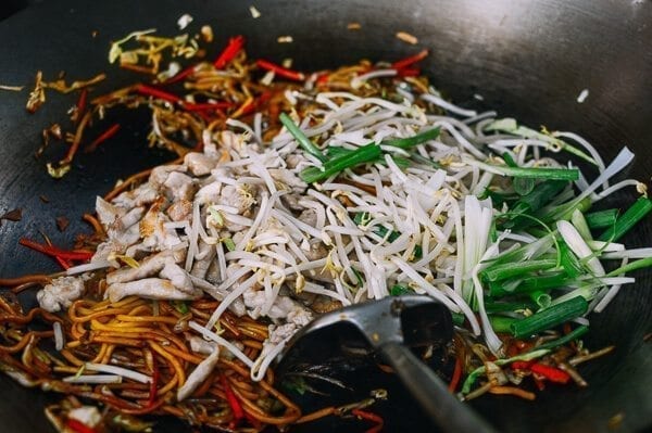 Adding bean sprouts and scallions at final stage of cooking, by thewoksoflife.com