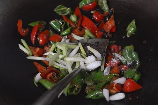 Peppers and scallions in wok, by thewoksoflife.com
