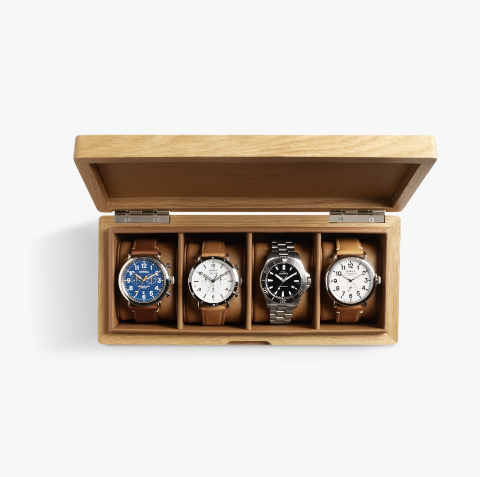 Open wooden Shinola watch box with leather compartments