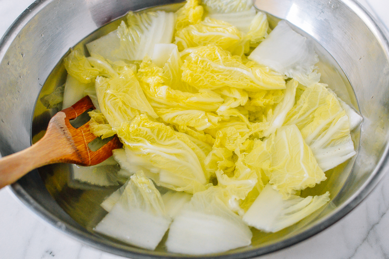 Blanched cabbage in bowl of water