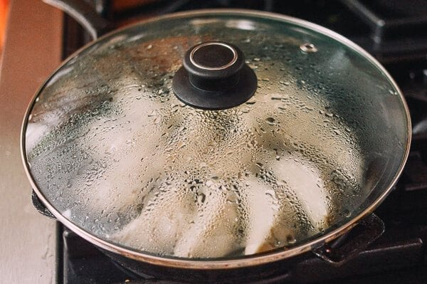 Steaming dumplings in frying pan, thewoksoflife.com