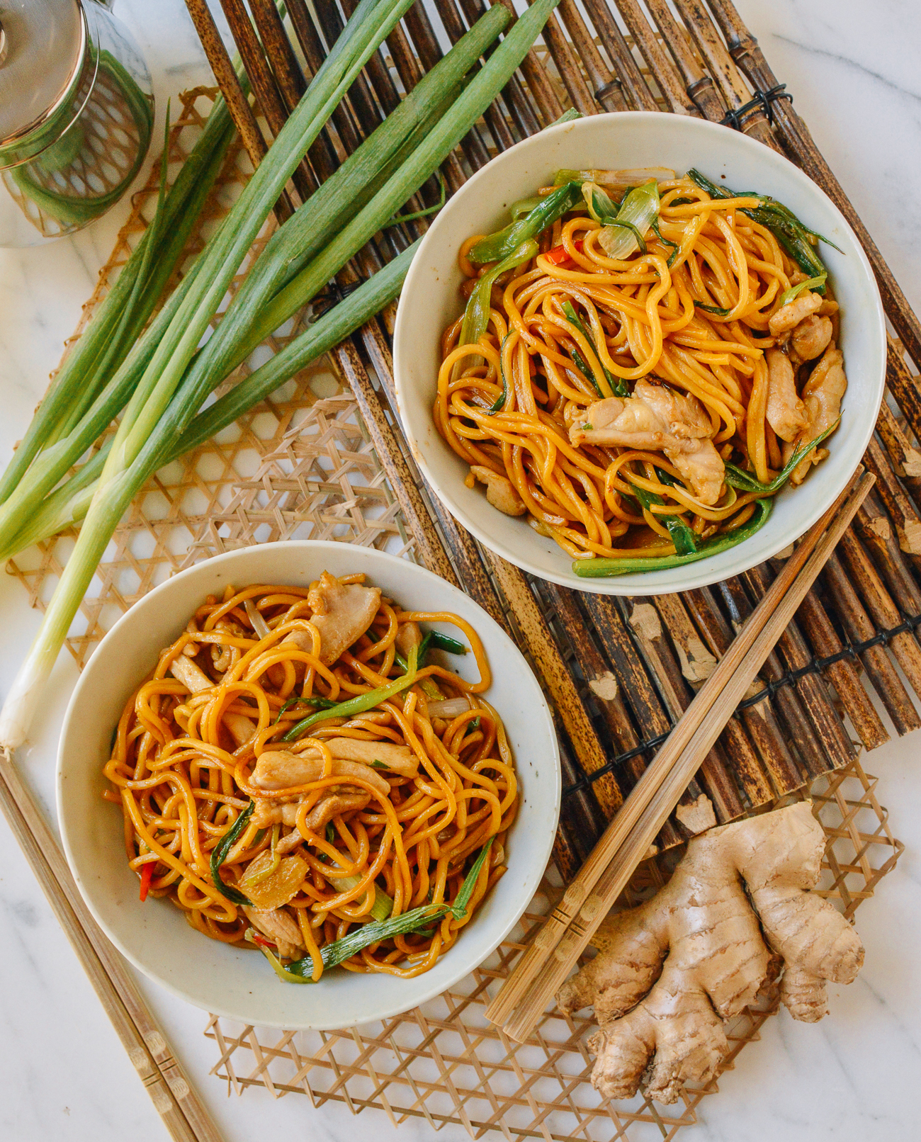 two bowls of Hokkien Noodles with ginger, scallion, and chicken