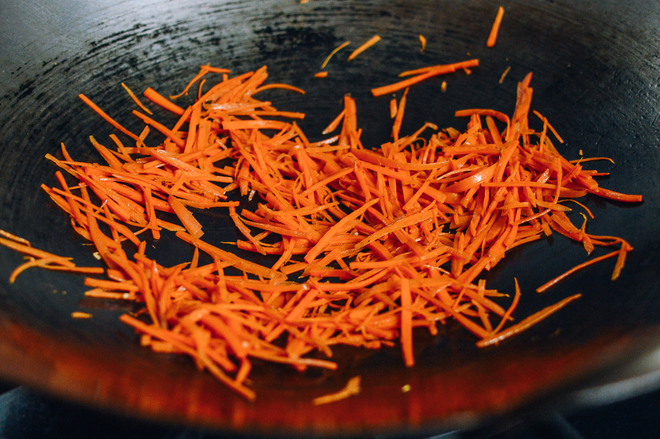 stir-frying julienned carrots in wok