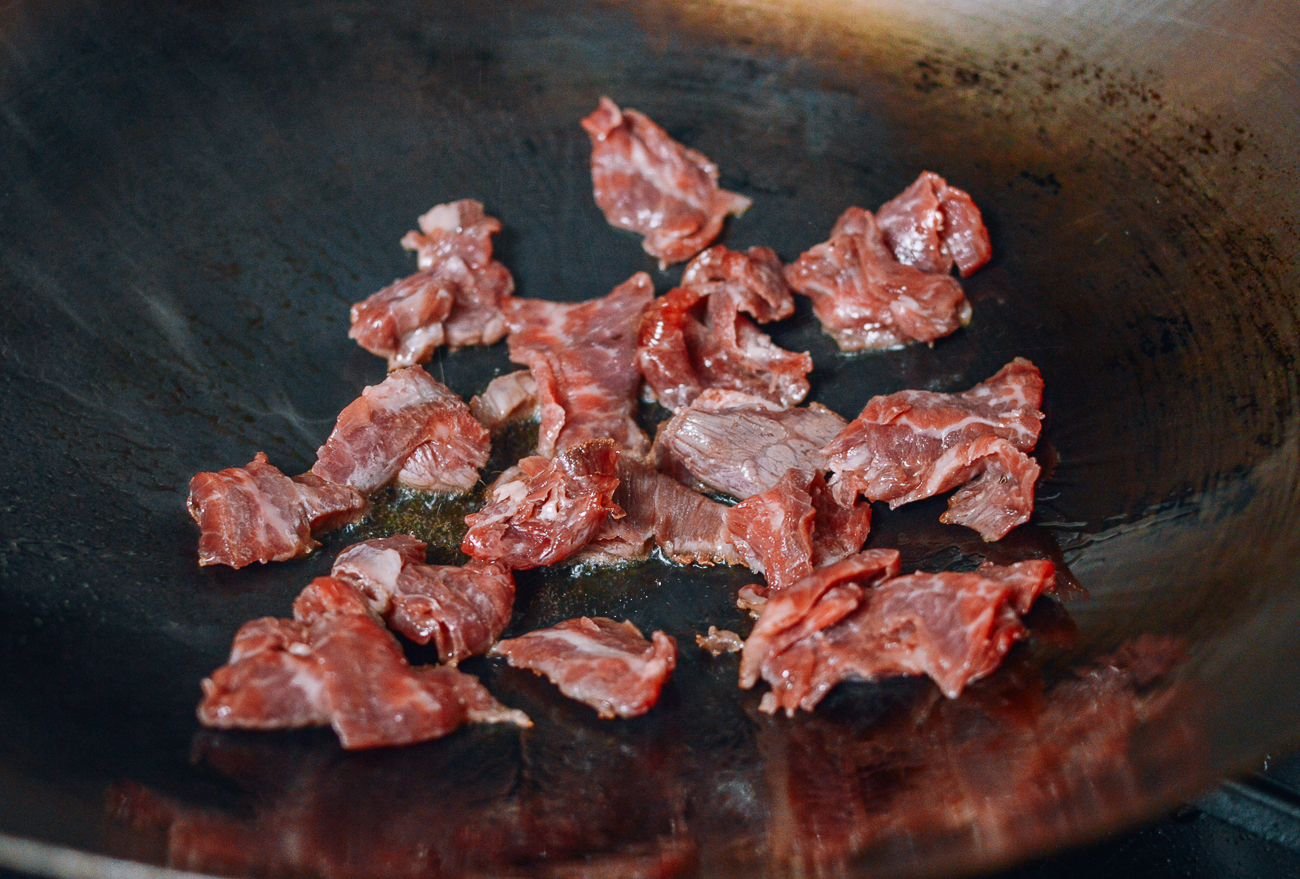 sliced beef searing in wok