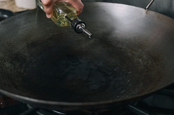 pouring oil into wok