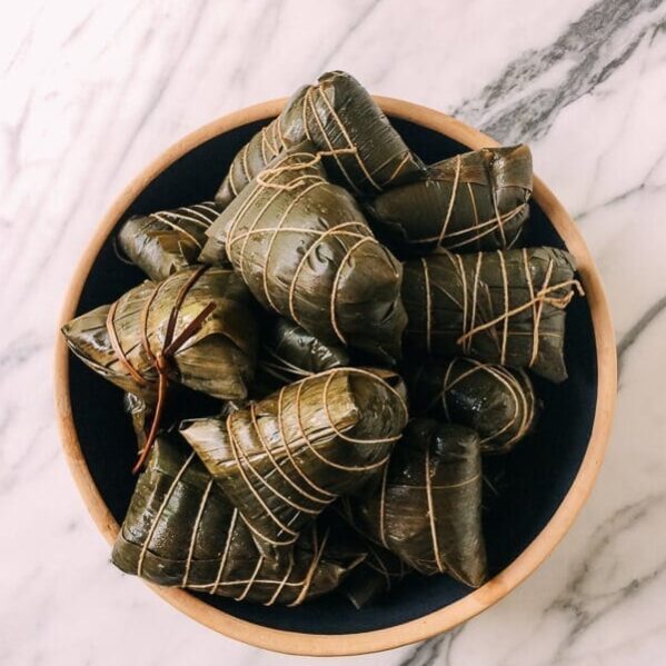 Wrapped Cooked zongzi (Sticky Rice Dumplings), by thewoksoflife.com