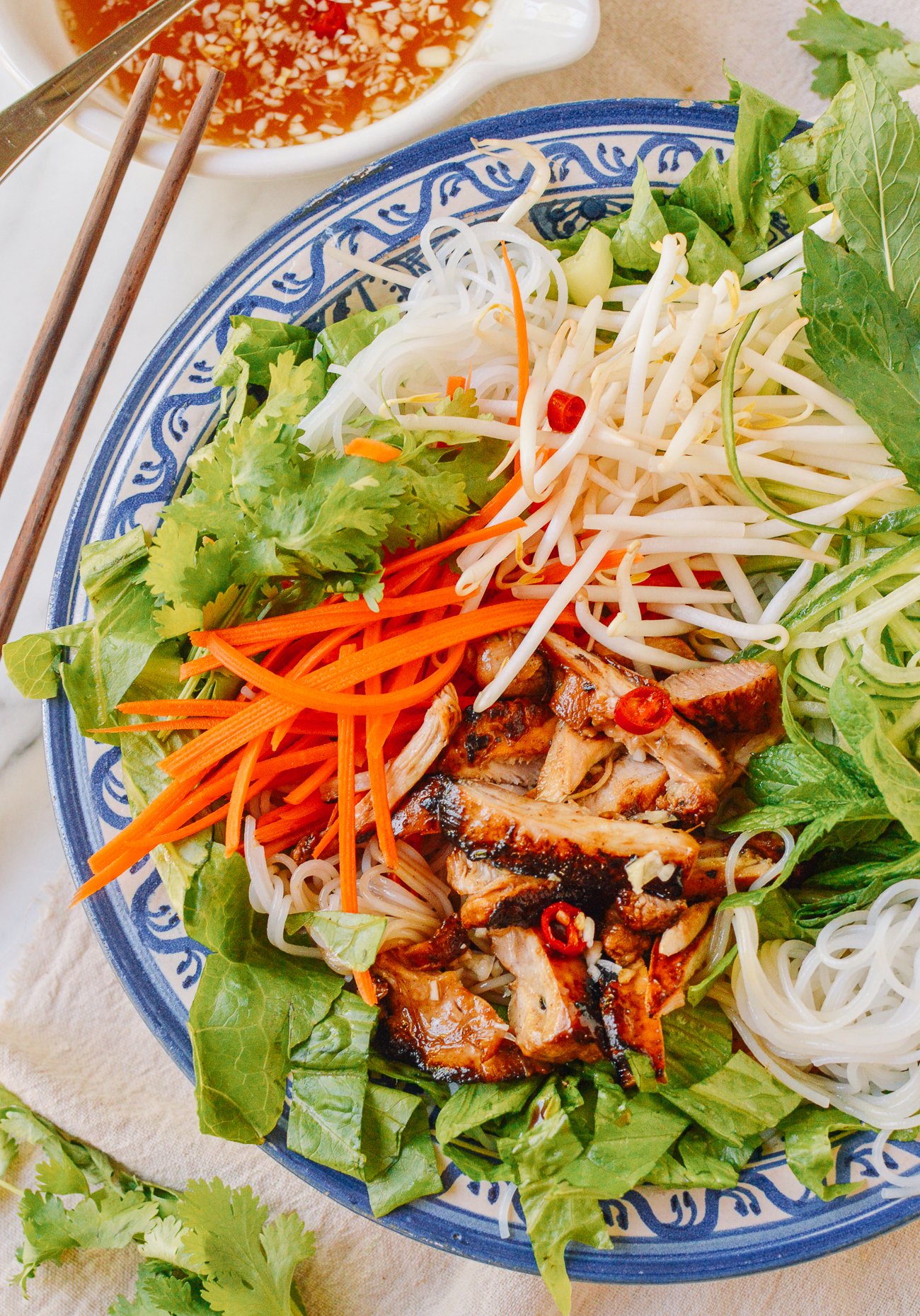 Vietnamese noodle salad with bean sprout, carrot, mint, grilled chicken, nuoc cham