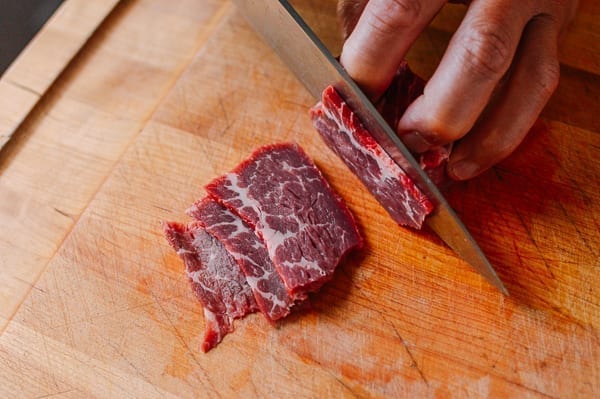 slicing beef chuck steak for stir-fry by thewoksoflife.com