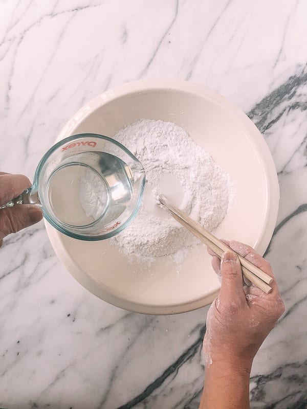 adding water to rice flour, by thewoksoflife.com