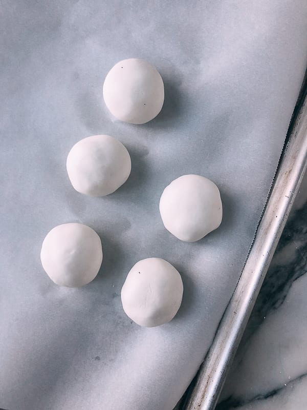 uncooked Savory Tang Yuan sitting on parchment paper, by thewoksoflife.com