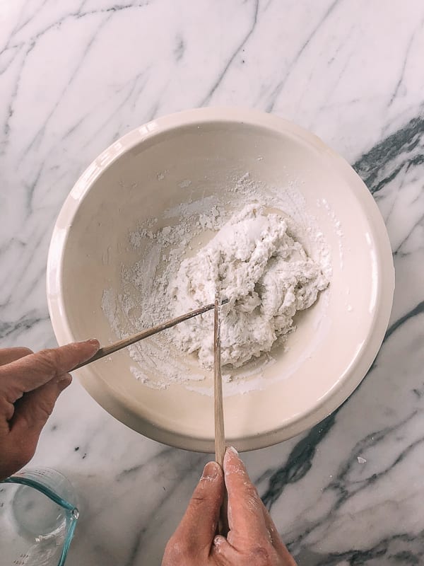 scraping rice dough off chopstick, by thewoksoflife.com