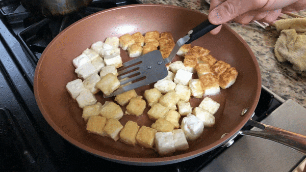 Flipping Pan-fried Tofu, by thewoksoflife.com