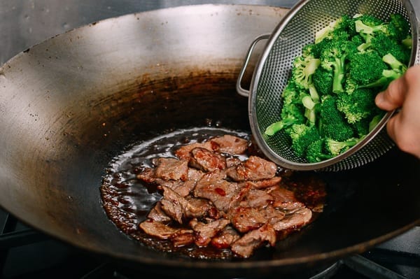 Adding beef and broccoli to wok, thewoksoflife.com