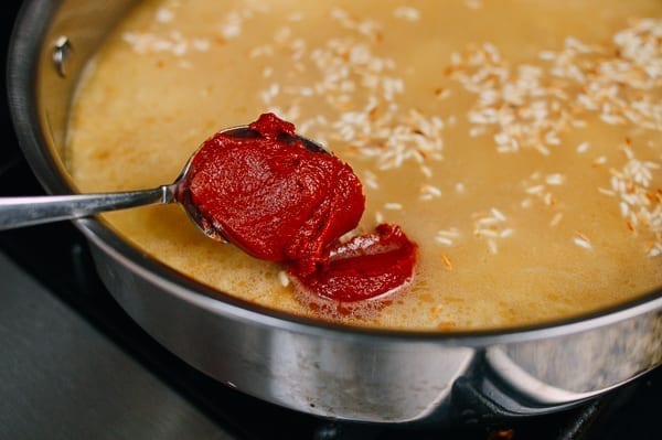 Adding tomato paste to mexican rice, thewoksoflife.com