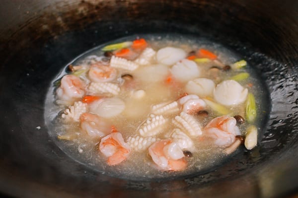 Seafood in white sauce in wok, thewoksoflife.com