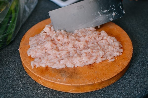 Hand chopping chicken breast, thewoksoflife.com