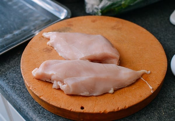 Two chicken breasts on cutting board, thewoksoflife.com