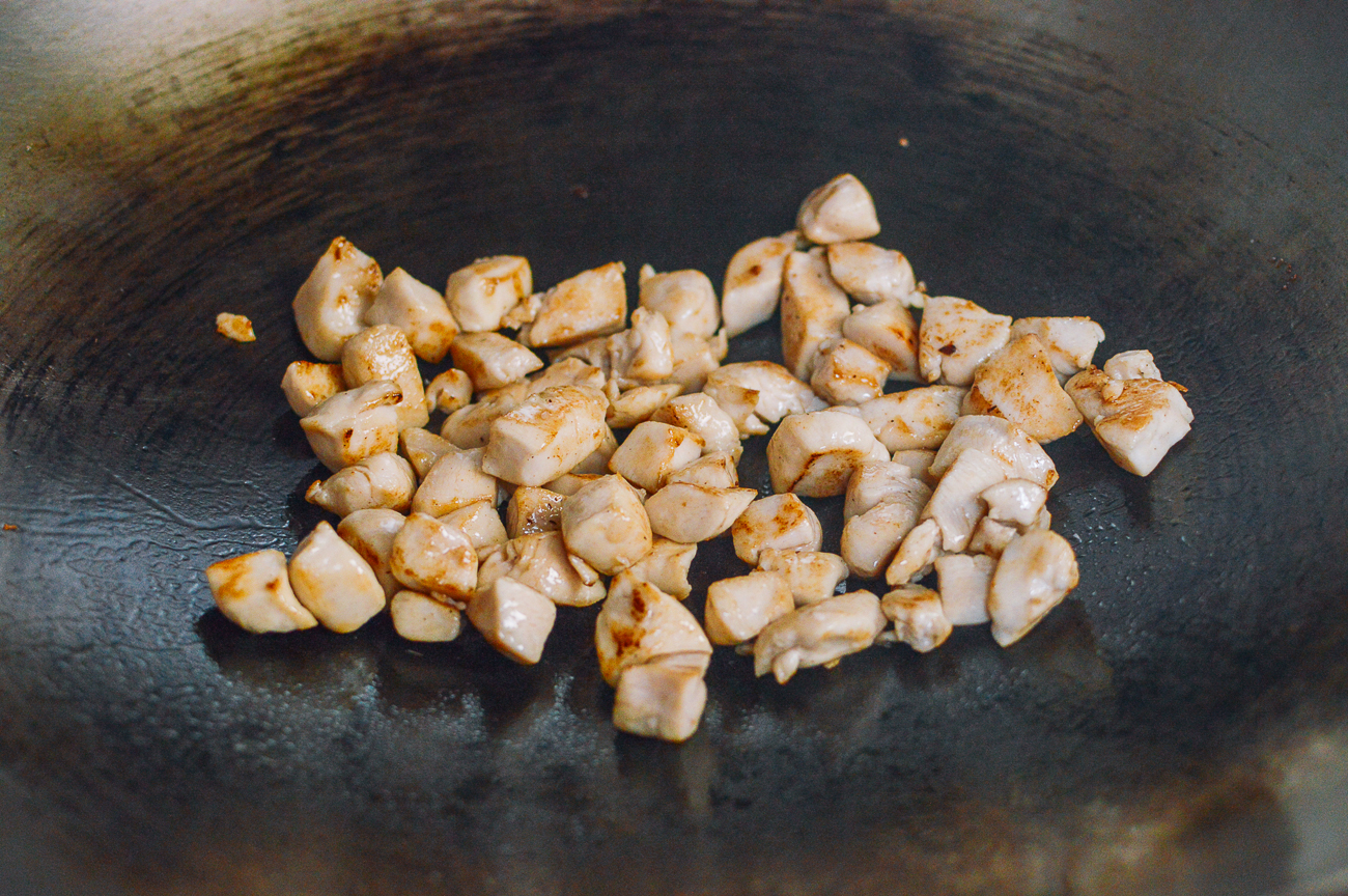 cooking chicken pieces in wok