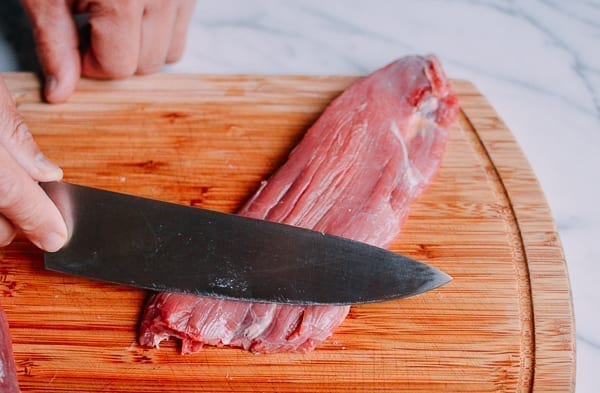 beef flank steak on a cutting board by thewoksoflife.com
