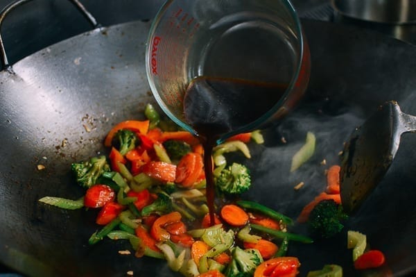 Adding stir-fry sauce to vegetables, thewoksoflife.com