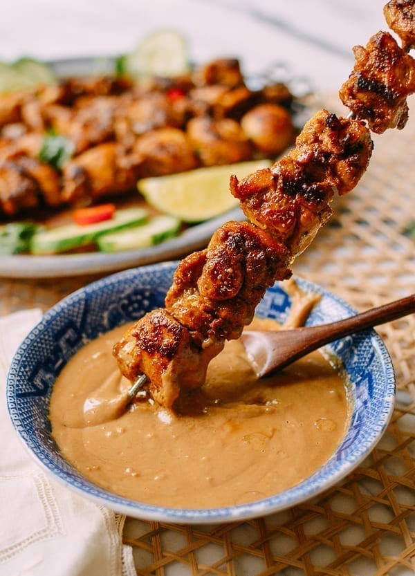 Dipping Chicken Satay into peanut sauce, thewoksoflife.com