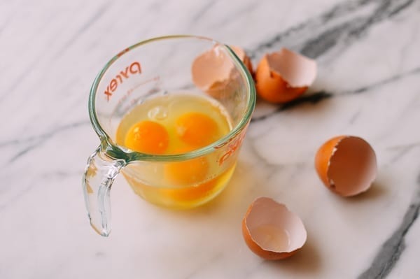 3 eggs cracked into liquid measuring cup, thewoksoflife.com
