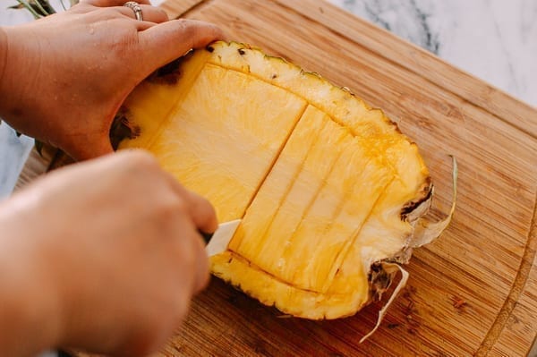 Cutting pineapple pieces, thewoksoflife.com