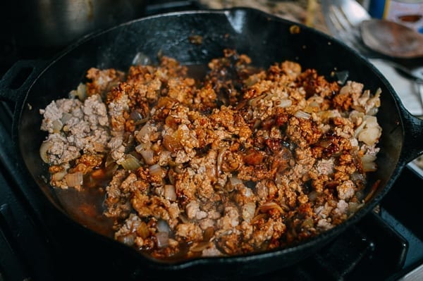 Adding sauce and seasoning to baozi filling, thewoksoflife.com