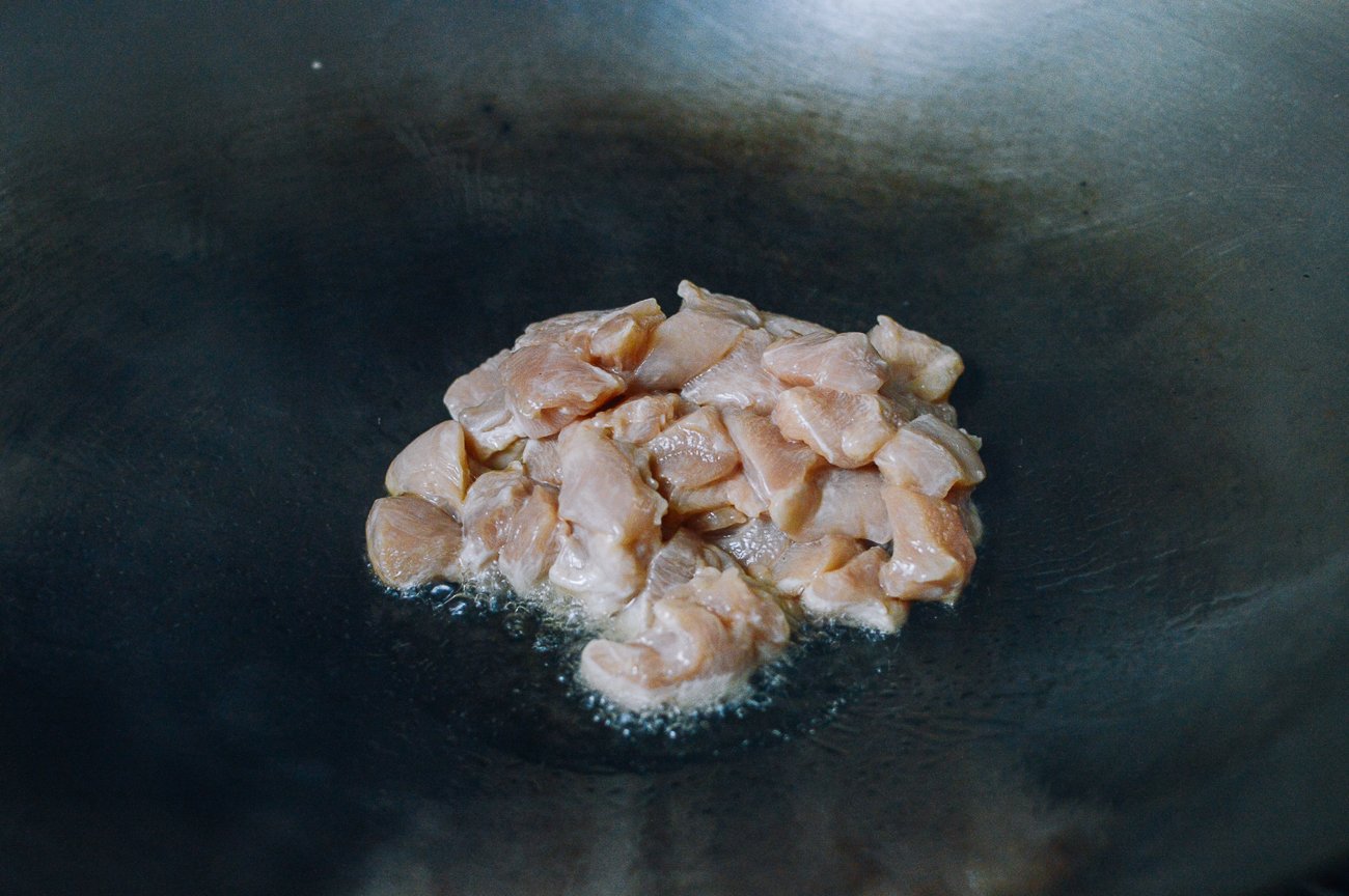 Chicken breast pieces in hot wok