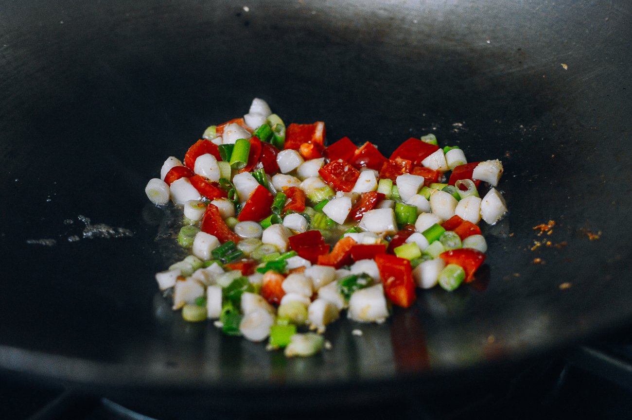 water chestnuts, peppers, and scallions in wok