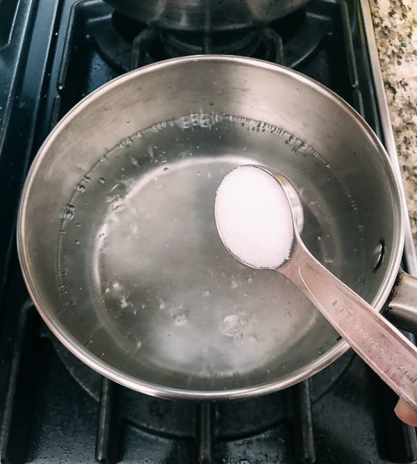 Adding salt to boiling water, thewoksoflife.com