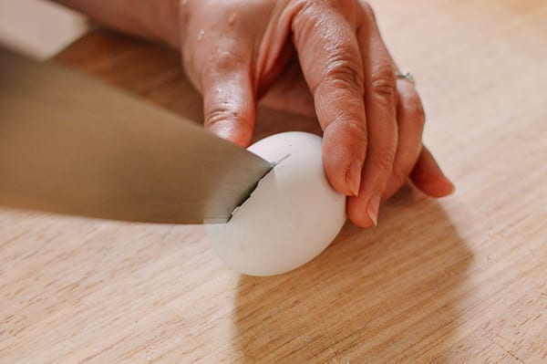 Cutting egg in half, thewoksoflife.com