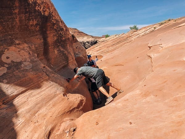 Climbing down Holeman Slot canyon - Moab Utah by thewoksoflife.com