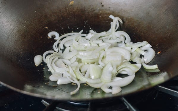Adding onions to wok, thewoksoflife.com